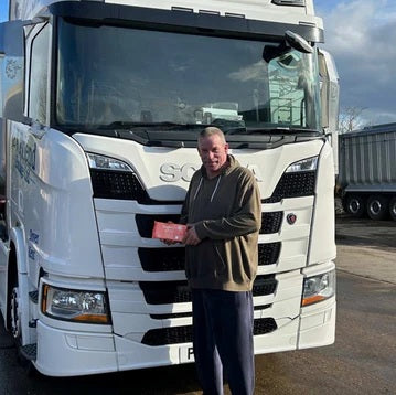 David standing next to his truck