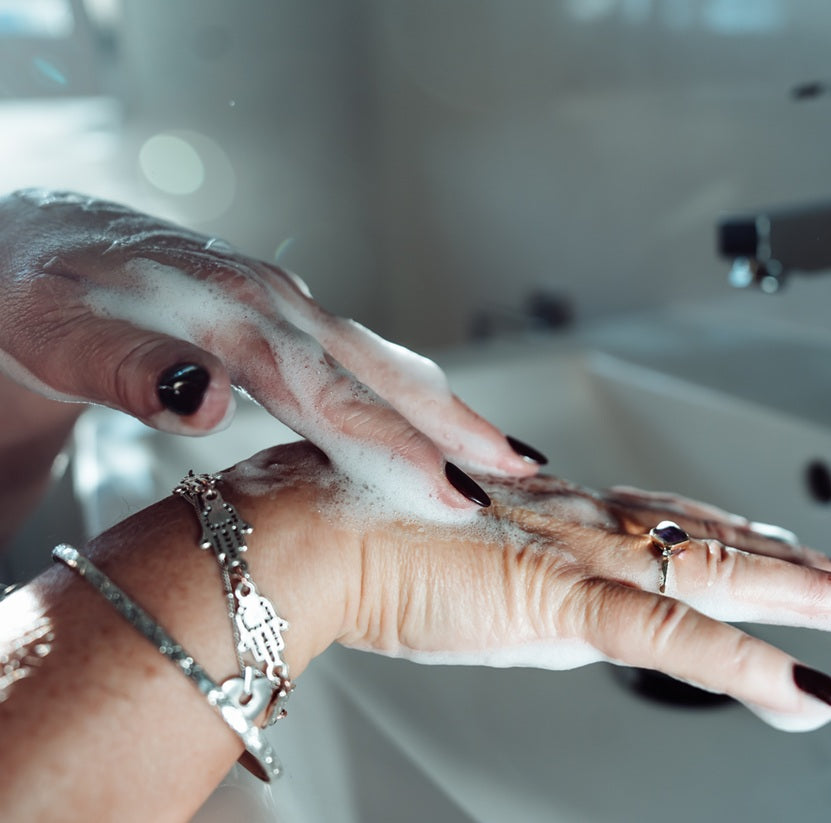 lady washing hands with body cleansing foam