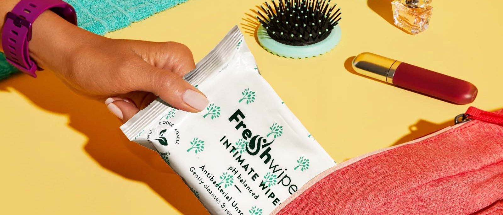 fresh wipes intimate wipes being taken out of a wash bag