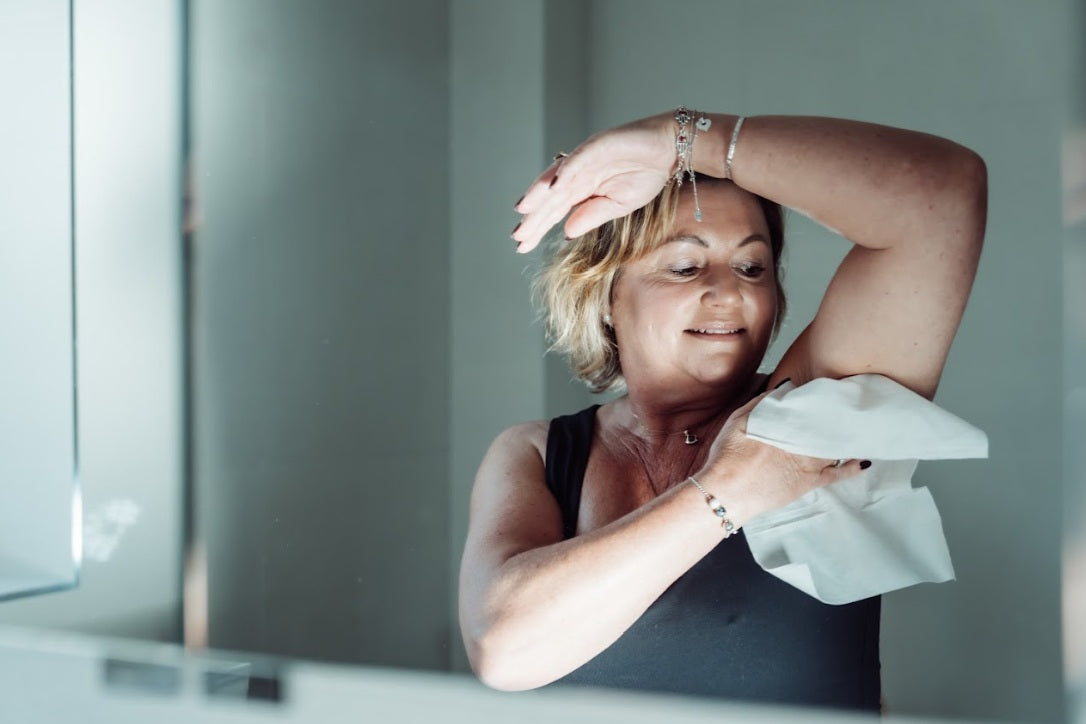 Lady washing with a body wipe